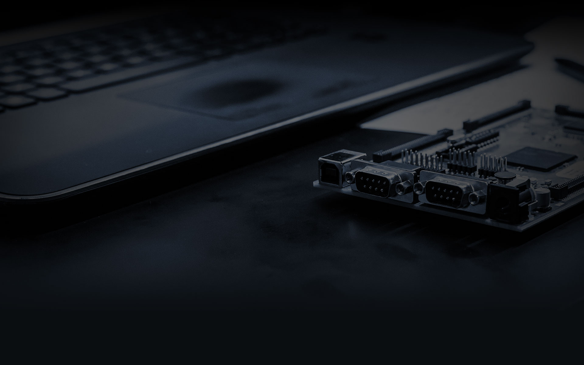 An ECU bench-programming interface beside a laptop